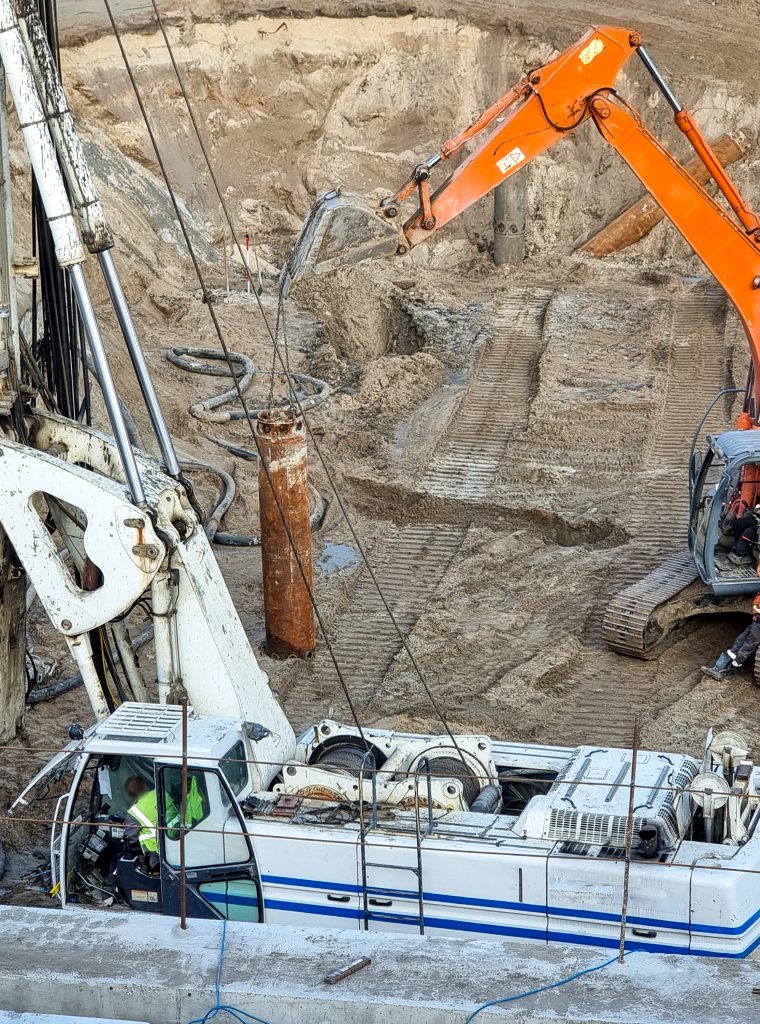 Closeup of heavy excavators and construction machines working on building site