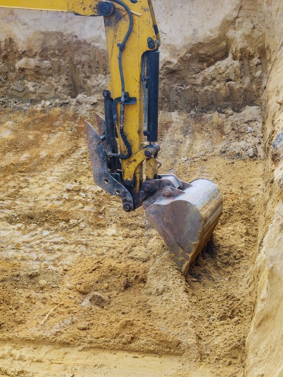 Construction with pile foundation at ground completed on excavator at earthworks