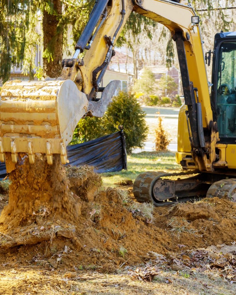 Construction works excavator moving earth, earthworks house construction